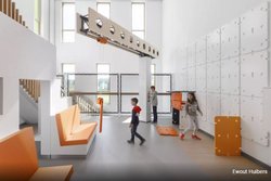 Weiß gestalteter Innenraum eines Kinderkrankenhauses mit orangenen Elementen. Zwei Jungen und ein Mädchen spielen.