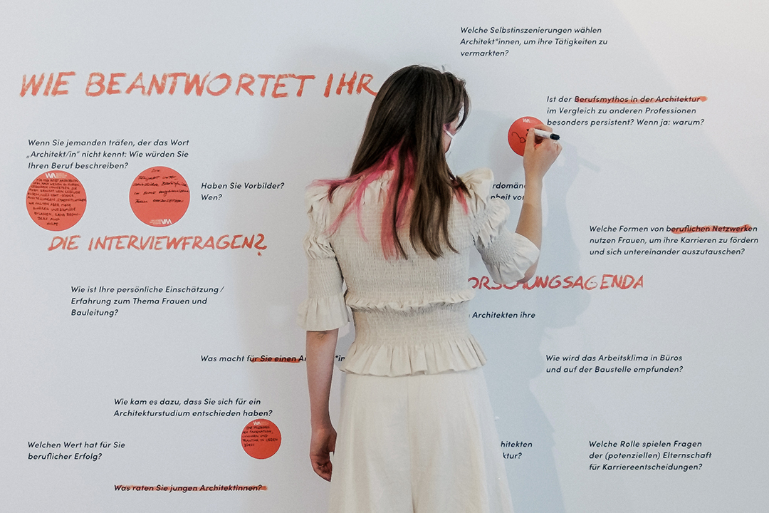 Rear view of woman in front of exhibition display