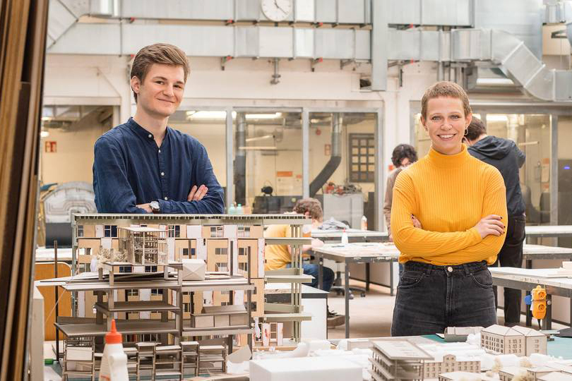 Two students at the studio with architecture models